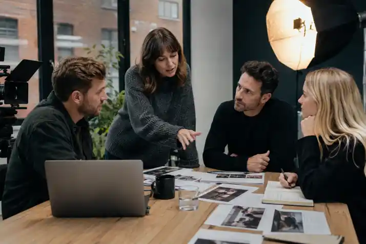 business video production team on location in Manchester city centre, video content strategy planning framework on whiteboard in agency meeting room, marketing video campaign multi-screen editing suite with timeline visible